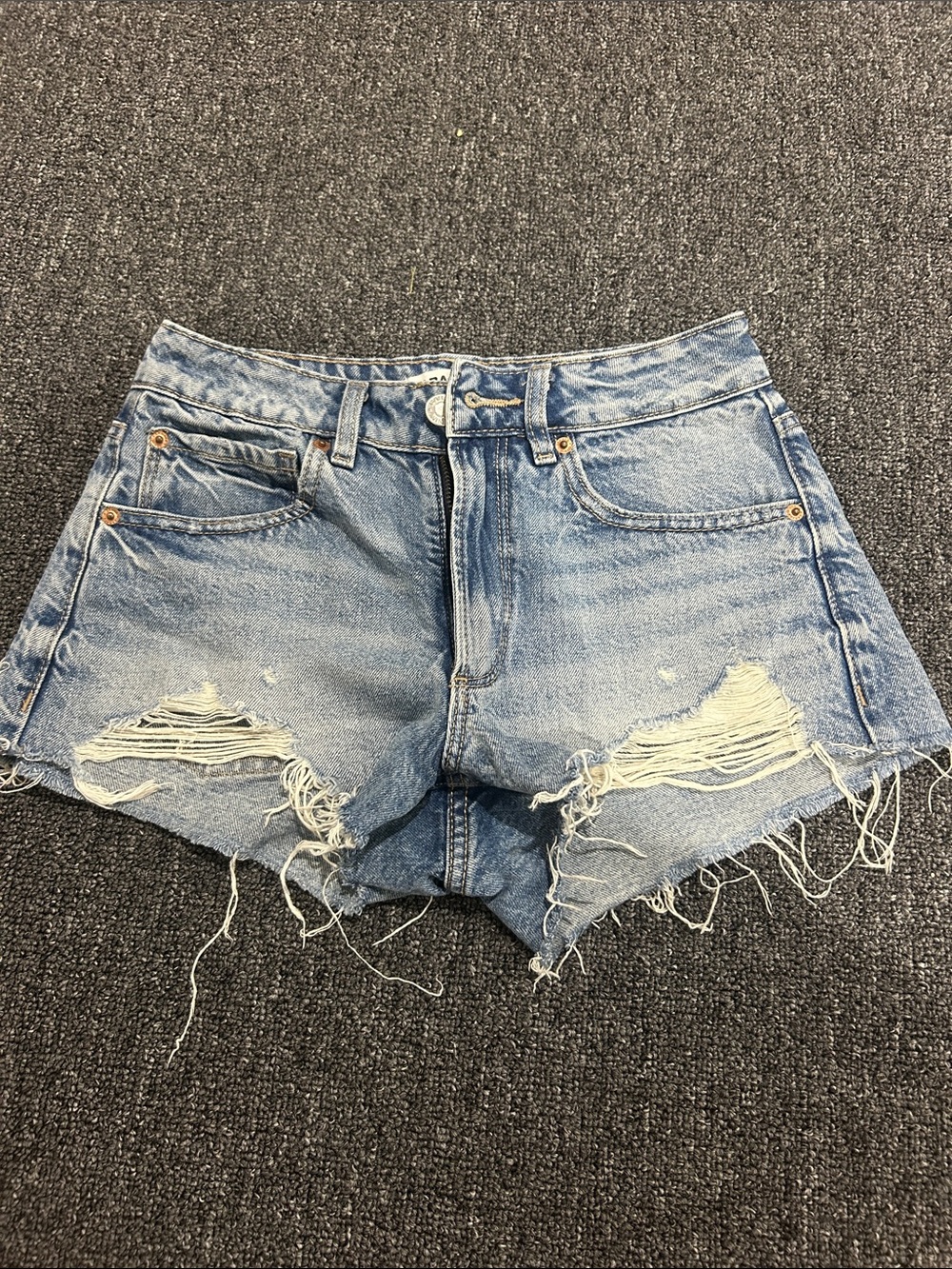 Low-Rise Distressed Light Blue Denim GARAGE festival shorts